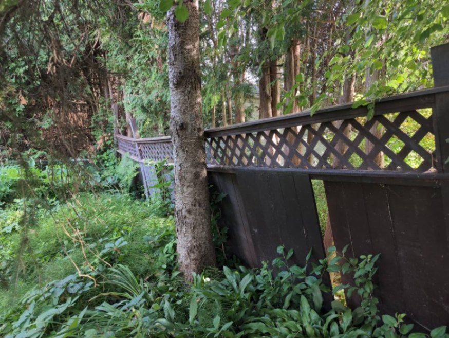 Customer-submitted photo of a failing fence estimated at 15+ years old (example 3)
