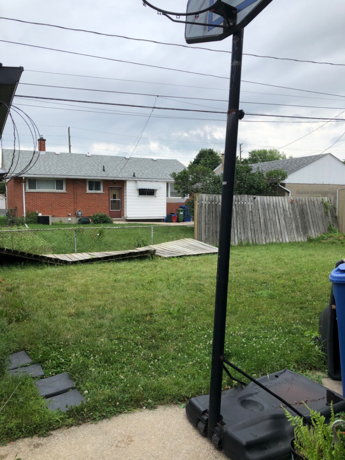 Customer-submitted photo of a failing fence estimated at 15+ years old (example 5)